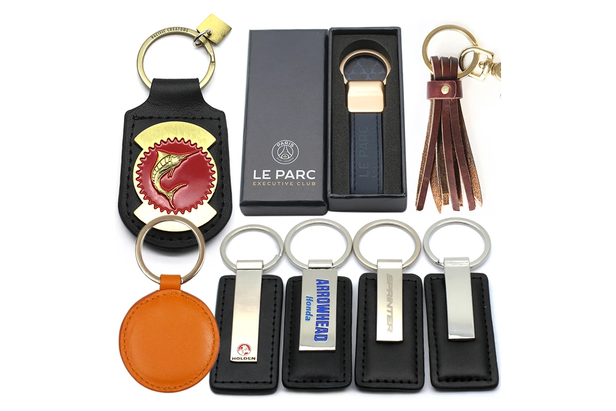 A selection of key fobs, including a black fob presented in a gift box.