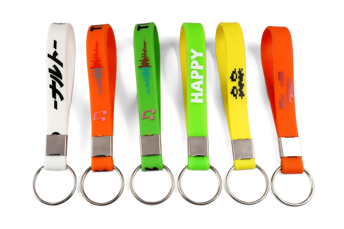 Bright silicone wristlet keychains with printed graphics and metal fittings.