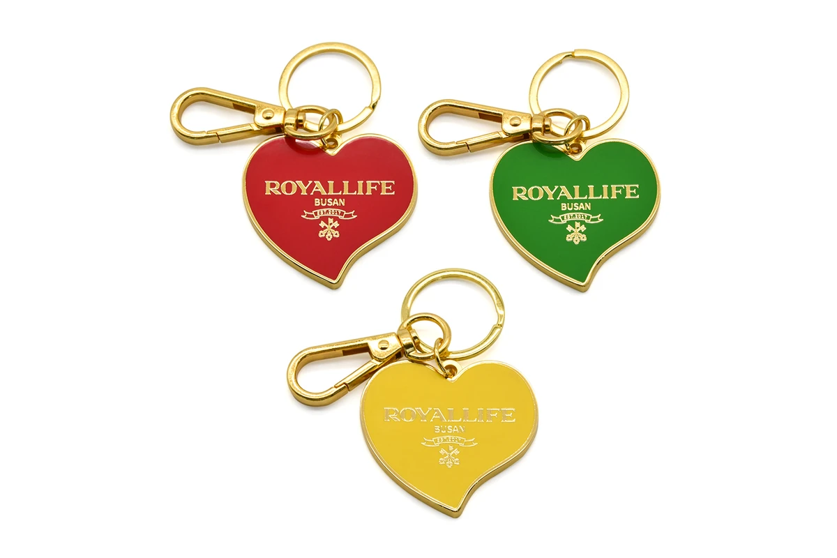 Heart-shaped metal keychains in red, green, and yellow with gold-tone fittings.